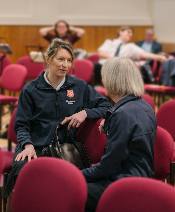 Salvation Army members talking to each other