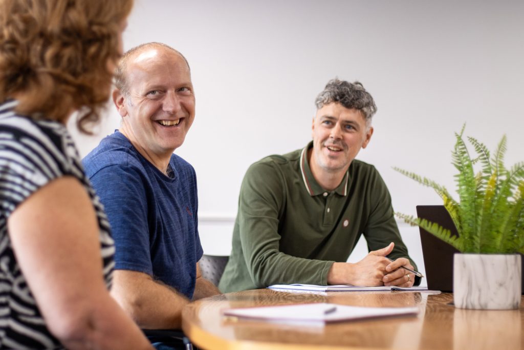An image of 3 people in a planning meeting